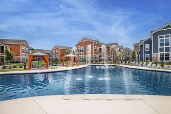 An outdoor swimming pool with apartments in the background